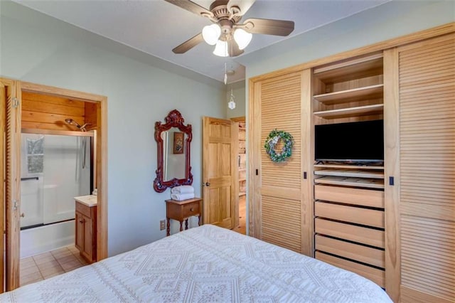 bedroom with ensuite bath, ceiling fan, and light tile patterned floors