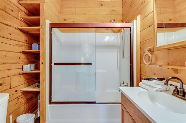 full bathroom with toilet, enclosed tub / shower combo, and wooden walls