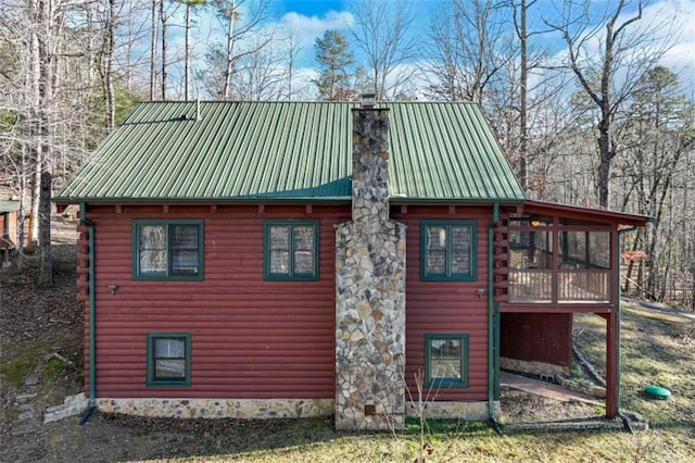 view of property exterior featuring a sunroom