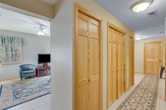 hall with light tile patterned floors