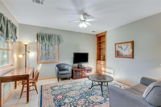 living room with ceiling fan and light tile patterned floors