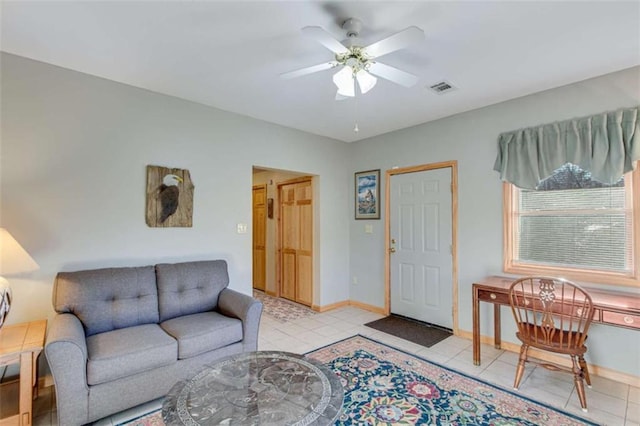 tiled living room featuring ceiling fan