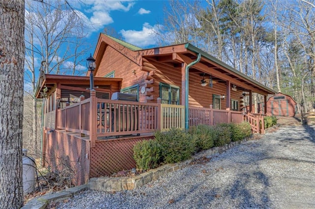 view of home's exterior featuring covered porch and a storage unit