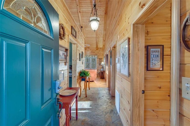 entryway featuring wood walls, high vaulted ceiling, and wood ceiling