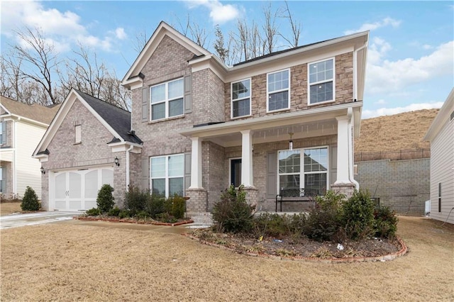 view of front of house with a garage, a front lawn, and a porch