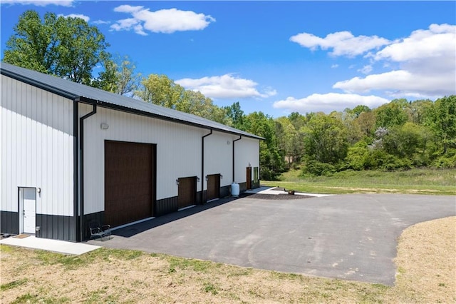 view of side of property with a garage and an outdoor structure