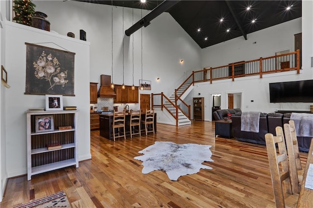 living room with a high ceiling and light wood-type flooring