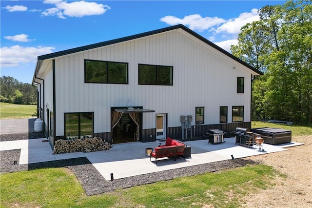 rear view of property featuring outdoor lounge area and a patio area