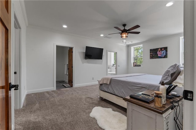 carpeted bedroom featuring ensuite bath, ceiling fan, and ornamental molding