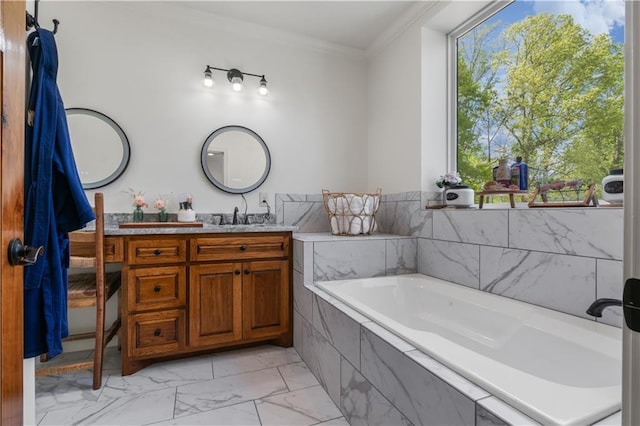 bathroom with vanity, ornamental molding, and tiled bath