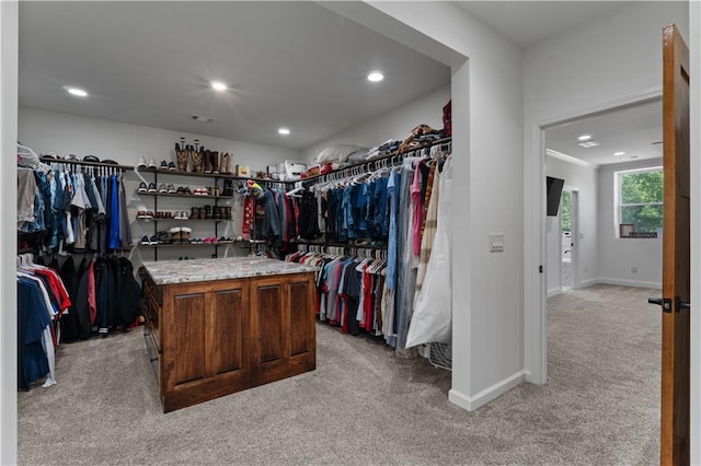 walk in closet featuring light colored carpet