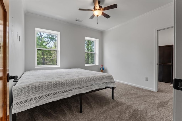 carpeted bedroom with ceiling fan and crown molding