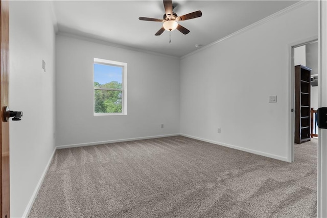 carpeted spare room with crown molding and ceiling fan