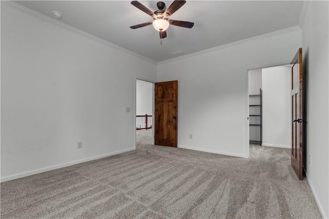 empty room with light carpet, ceiling fan, and crown molding