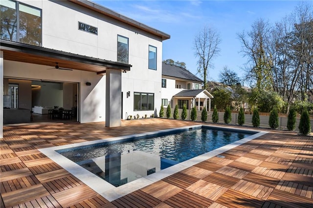 view of swimming pool featuring a fenced in pool, a patio area, fence, and ceiling fan