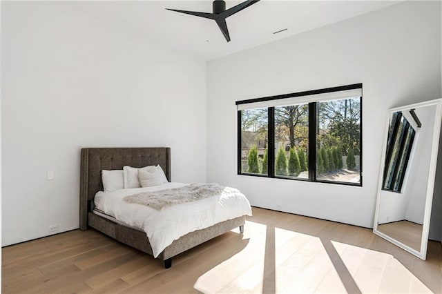 bedroom with a ceiling fan and light wood-style flooring