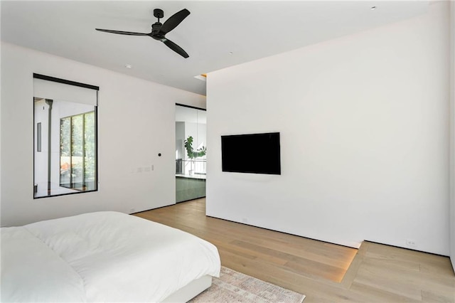 bedroom featuring ceiling fan and wood finished floors