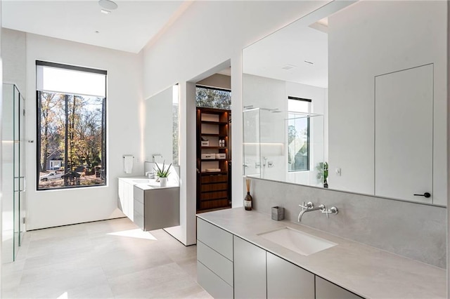 full bathroom featuring tasteful backsplash, walk in shower, and vanity