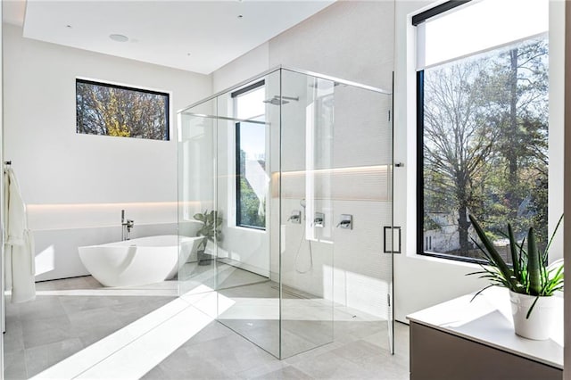 full bath featuring a stall shower and a soaking tub