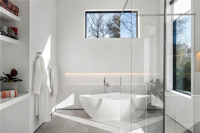 full bath with a stall shower, a soaking tub, and tile patterned flooring