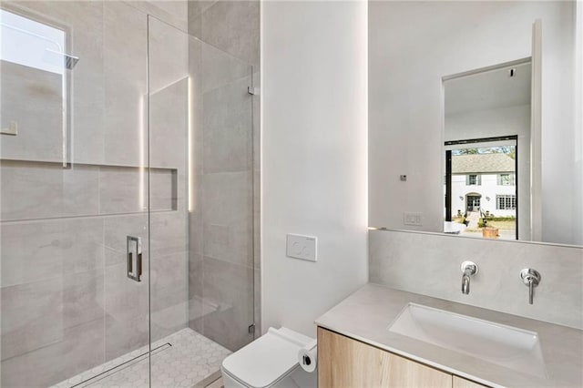 full bath featuring toilet, a shower stall, decorative backsplash, and vanity