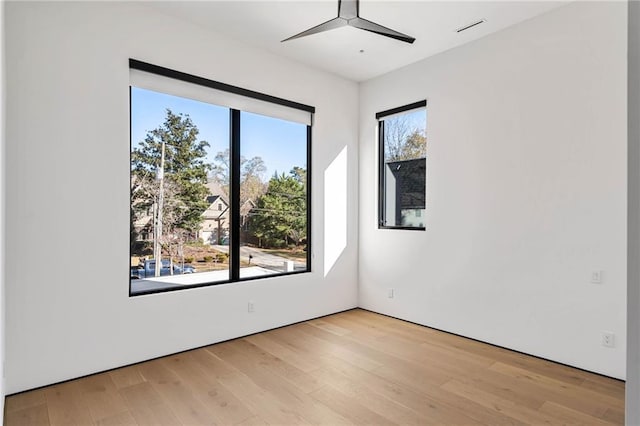 unfurnished room featuring light wood-style floors and a ceiling fan