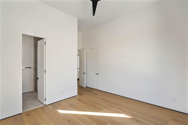 unfurnished bedroom with light wood-type flooring and a ceiling fan