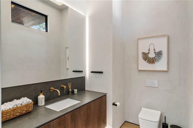 bathroom featuring backsplash, vanity, and toilet