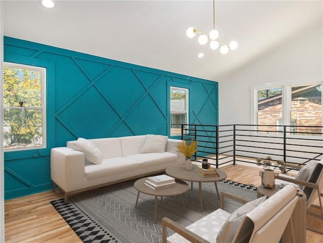 living room with vaulted ceiling, recessed lighting, and light wood-style floors