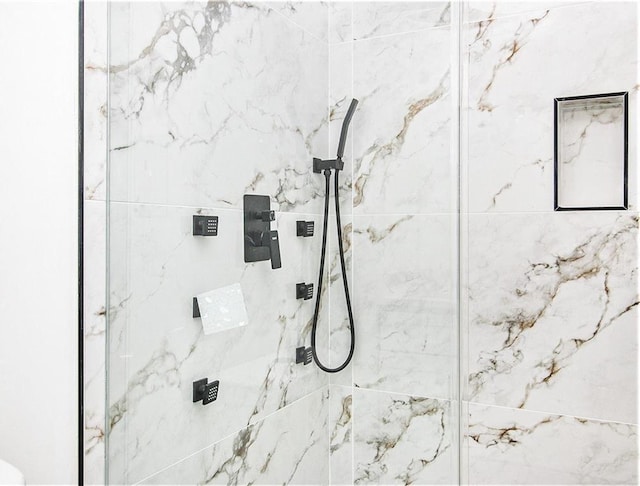 bathroom with a marble finish shower