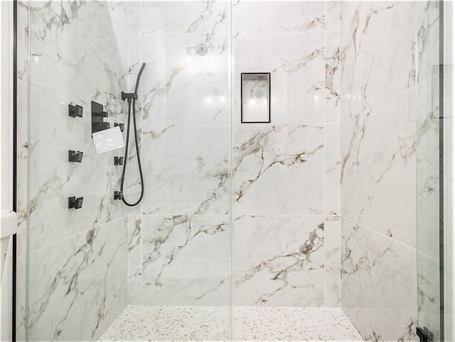 bathroom with a marble finish shower