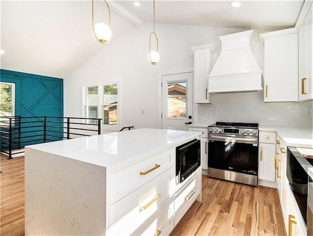 kitchen with light wood finished floors, backsplash, built in microwave, stainless steel range with gas stovetop, and custom exhaust hood