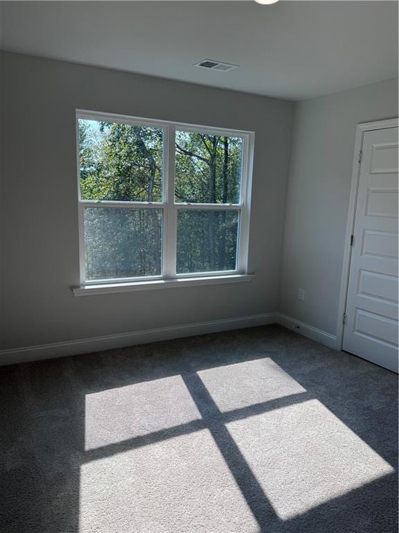 empty room featuring dark carpet