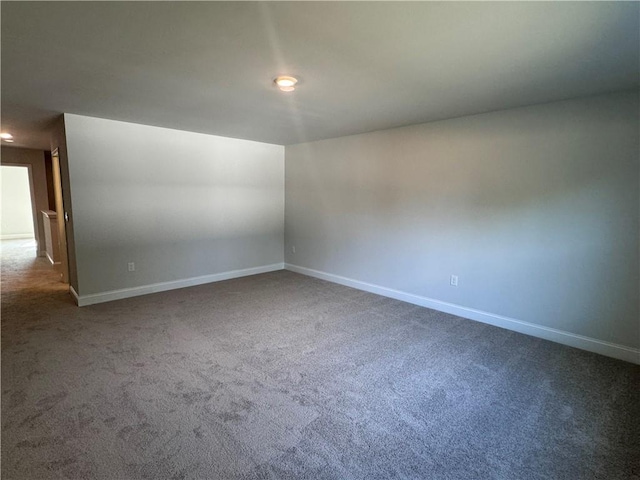 empty room featuring dark colored carpet