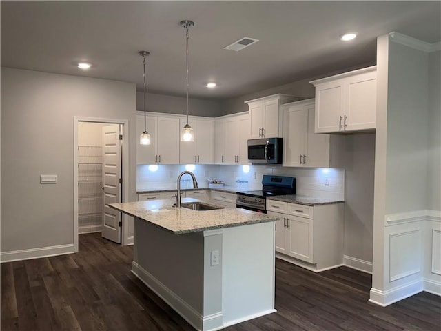 kitchen with white cabinets, sink, light stone countertops, an island with sink, and appliances with stainless steel finishes