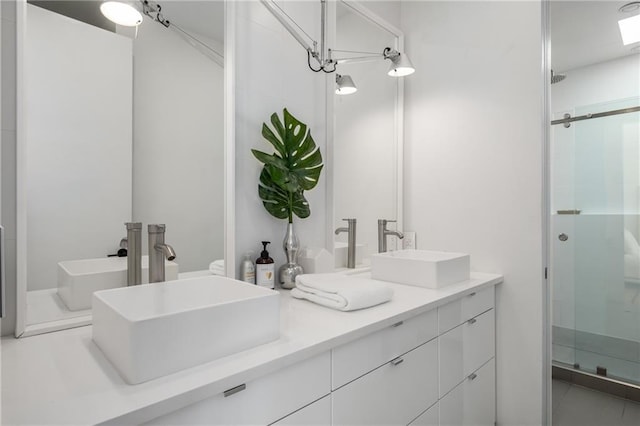 bathroom with vanity and a shower with shower door