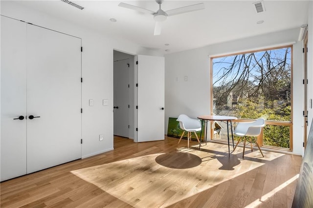 living area featuring light hardwood / wood-style flooring and ceiling fan