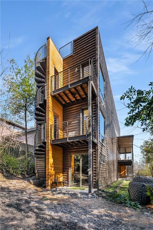 back of house featuring a balcony