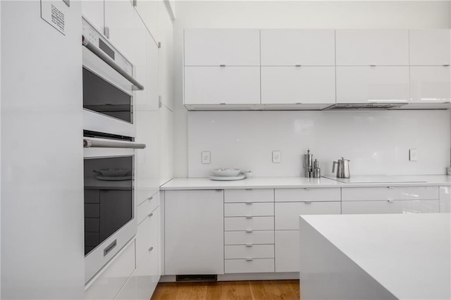 kitchen featuring white cabinetry and light wood-type flooring