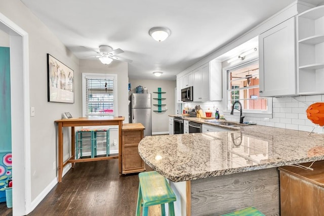 5400 Francis Ave, Stone Mountain, GA 30087 - kitchen featuring open shelves, appliances with stainless steel finishes, tasteful backsplash, and baseboards