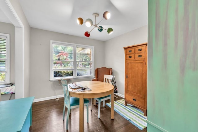 5400 Francis Ave, Stone Mountain, GA 30087 - dining space featuring a chandelier, dark wood-type flooring, and baseboards