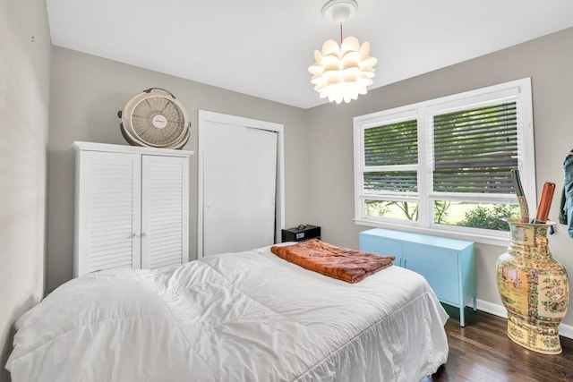 5400 Francis Ave, Stone Mountain, GA 30087 - bedroom with dark wood finished floors, a closet, baseboards, and a chandelier