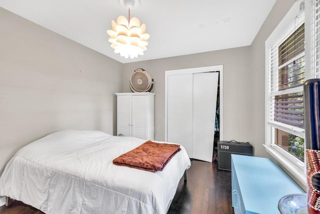 5400 Francis Ave, Stone Mountain, GA 30087 - bedroom with dark wood-style floors, a chandelier, and a closet
