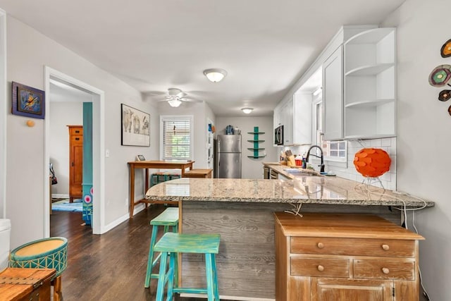 5400 Francis Ave, Stone Mountain, GA 30087 - kitchen with freestanding refrigerator, open shelves, a sink, a ceiling fan, and backsplash