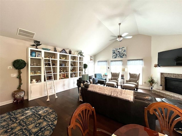 living room with a fireplace, vaulted ceiling, ceiling fan, and dark hardwood / wood-style floors