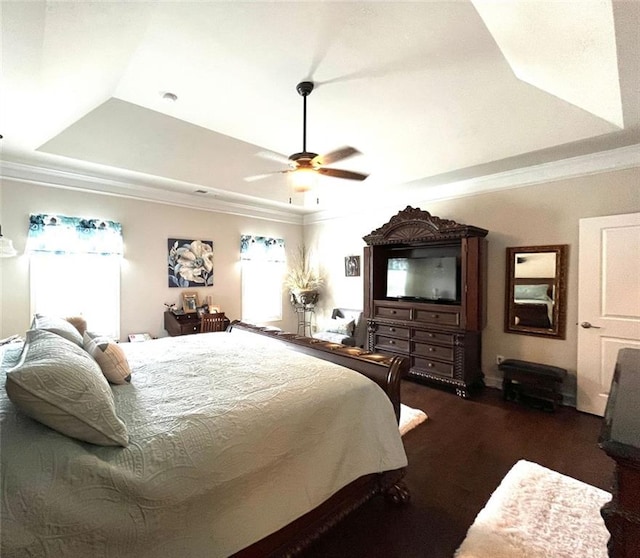 bedroom with a tray ceiling, crown molding, and ceiling fan