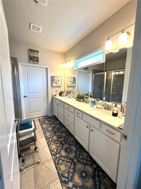 bathroom featuring vanity and a shower with door