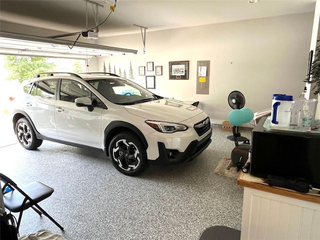 garage with a garage door opener and electric panel