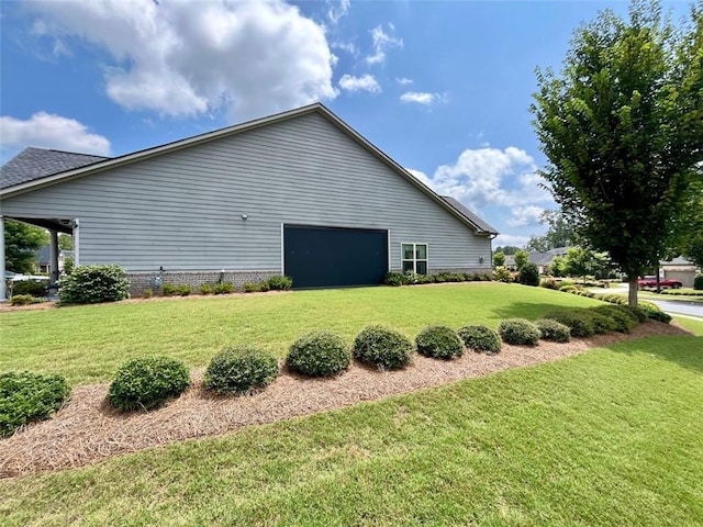 view of side of property with a garage and a lawn