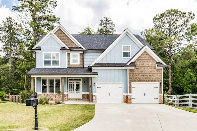 craftsman house with a garage, a front lawn, and covered porch